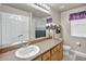Bright bathroom with a single sink vanity and a shower-tub combination at 6932 Gray Catbird Loop, Wesley Chapel, FL 33545