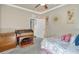 Bedroom featuring a piano, ceiling fan, and closet space at 6932 Gray Catbird Loop, Wesley Chapel, FL 33545