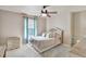 Cozy bedroom featuring a neutral color scheme, a ceiling fan, and a dresser at 6932 Gray Catbird Loop, Wesley Chapel, FL 33545