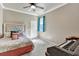 Bedroom with ceiling fan and decorative accents, featuring a unique piano at 6932 Gray Catbird Loop, Wesley Chapel, FL 33545