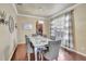 Elegant dining room featuring hardwood floors, modern lighting, and a large window at 6932 Gray Catbird Loop, Wesley Chapel, FL 33545