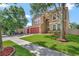 Charming home featuring a well-manicured lawn, lush landscaping, and a two-car garage at 6932 Gray Catbird Loop, Wesley Chapel, FL 33545
