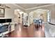 Open-concept living area featuring hardwood floors and arched doorways leading to other rooms at 6932 Gray Catbird Loop, Wesley Chapel, FL 33545