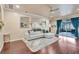 Bright living room featuring hardwood floors, neutral walls, and a sliding glass door to the screened-in patio at 6932 Gray Catbird Loop, Wesley Chapel, FL 33545