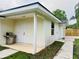 Exterior view showcasing a cozy covered patio and outdoor grill, perfect for entertaining guests at 801 Leeward Way, Palm Harbor, FL 34685