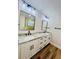 Bathroom vanity featuring double sinks with granite counters and matte black fixtures at 801 Leeward Way, Palm Harbor, FL 34685
