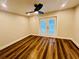 Bedroom with double doors leading to outdoor space and hardwood floors at 801 Leeward Way, Palm Harbor, FL 34685