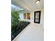 Inviting front entrance with decorative landscaping and a modern glass-paneled door, enhancing curb appeal at 801 Leeward Way, Palm Harbor, FL 34685