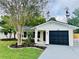 Charming home featuring a well-manicured lawn and complemented by a freshly painted exterior with lush landscaping at 801 Leeward Way, Palm Harbor, FL 34685
