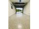 Spacious two-car garage featuring epoxy floor and overhead door to driveway at 801 Leeward Way, Palm Harbor, FL 34685