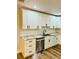 Kitchen featuring white cabinets, granite counters, and stainless appliances at 801 Leeward Way, Palm Harbor, FL 34685