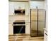 Bright kitchen features stainless appliances and white cabinets at 801 Leeward Way, Palm Harbor, FL 34685