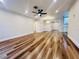 Spacious living room with wood-look flooring, recessed lighting, and a modern ceiling fan at 801 Leeward Way, Palm Harbor, FL 34685