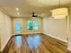 Bright and airy living room features stylish wood-look floors and modern lighting fixtures, creating a welcoming space at 801 Leeward Way, Palm Harbor, FL 34685