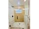 Modern shower featuring seamless glass doors, mosaic tile floor, and tiled walls at 801 Leeward Way, Palm Harbor, FL 34685