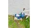 Home's well pump unit on concrete slab surrounded by grass and plumbing at 801 Leeward Way, Palm Harbor, FL 34685
