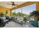 Relaxing screened-in balcony with seating, plants, and view of the surrounding area at 1061 Pinellas Bayway S, Tierra Verde, FL 33715