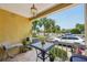 Charming balcony with outdoor seating and potted plants, offering a view of the lush surroundings at 1061 Pinellas Bayway S, Tierra Verde, FL 33715