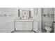 Bathroom featuring double sinks, vanity cabinet storage, and a toilet at 1061 Pinellas Bayway S, Tierra Verde, FL 33715