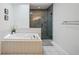 Bathroom with soaking tub and walk-in shower at 1061 Pinellas Bayway S, Tierra Verde, FL 33715