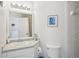 Bathroom featuring tiled shower and all-white decor with a small sink at 1061 Pinellas Bayway S, Tierra Verde, FL 33715