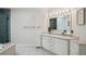Bright bathroom with double sinks, walk-in shower, and separate tub at 1061 Pinellas Bayway S, Tierra Verde, FL 33715