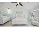 Light-filled bedroom features a ceiling fan, a painting, and windows offers a relaxing retreat at 1061 Pinellas Bayway S, Tierra Verde, FL 33715