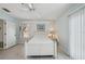 Bright bedroom with white furniture, a ceiling fan, and a window creates a relaxing ambiance at 1061 Pinellas Bayway S, Tierra Verde, FL 33715