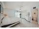 Bedroom featuring a ceiling fan, closet, and en suite bathroom at 1061 Pinellas Bayway S, Tierra Verde, FL 33715