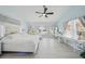 Large bedroom with many windows, a ceiling fan, and a desk provides ample natural light and space at 1061 Pinellas Bayway S, Tierra Verde, FL 33715