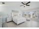 Bright bedroom with a ceiling fan, a painting, and windows creates a serene and airy atmosphere at 1061 Pinellas Bayway S, Tierra Verde, FL 33715