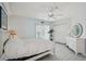 Bright bedroom features a large bed, white dressers, and sliding glass door to a balcony with views at 1061 Pinellas Bayway S, Tierra Verde, FL 33715