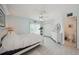 Bedroom featuring a ceiling fan, closet, and en suite bathroom at 1061 Pinellas Bayway S, Tierra Verde, FL 33715