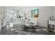 Dining room with modern light fixtures, white furniture, and decorative coastal painting at 1061 Pinellas Bayway S, Tierra Verde, FL 33715