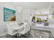 Open-plan dining area with unique light fixtures and a view into the living room at 1061 Pinellas Bayway S, Tierra Verde, FL 33715