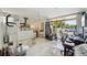 Spacious exercise room with workout equipment, a desk, and a balcony with natural light at 1061 Pinellas Bayway S, Tierra Verde, FL 33715