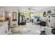 Bright exercise room with gym equipment, desk, and balcony access, featuring modern epoxy flooring at 1061 Pinellas Bayway S, Tierra Verde, FL 33715