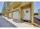 Inviting townhome front entrance with garage, wreath and neutral color scheme at 1061 Pinellas Bayway S, Tierra Verde, FL 33715