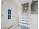 Bright entryway with staircase and decorative beach sign at 1061 Pinellas Bayway S, Tierra Verde, FL 33715