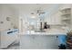 Bright kitchen boasts white countertops, white cabinets, and an eat-in nook at 1061 Pinellas Bayway S, Tierra Verde, FL 33715