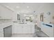 Open kitchen features white cabinetry and stainless steel appliances at 1061 Pinellas Bayway S, Tierra Verde, FL 33715