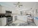 Open kitchen has stainless steel appliances, white cabinetry and countertops at 1061 Pinellas Bayway S, Tierra Verde, FL 33715