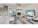 Bright and airy living room boasting modern fireplace and marble-look floors at 1061 Pinellas Bayway S, Tierra Verde, FL 33715