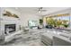 Open living room featuring modern fireplace, elegant marble floors, and balcony at 1061 Pinellas Bayway S, Tierra Verde, FL 33715