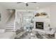 Bright open-concept living room featuring a fireplace, unique floors, and staircase at 1061 Pinellas Bayway S, Tierra Verde, FL 33715