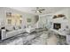 Comfortable living room with fireplace, marble floors, and open floor plan at 1061 Pinellas Bayway S, Tierra Verde, FL 33715