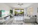 Bright living room featuring marble floors and a balcony overlooking lush landscaping at 1061 Pinellas Bayway S, Tierra Verde, FL 33715