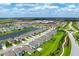 Expansive aerial view capturing the community's landscaping, the pond, and the school in the distance at 3255 Hilltop Cir, Bradenton, FL 34211