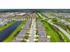 Wide aerial shot of the community featuring ponds, meticulously maintained landscaping, and a school nearby at 3255 Hilltop Cir, Bradenton, FL 34211