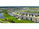 Drone image showcases the backyard's patio, along with the community's landscaping and pond views at 3255 Hilltop Cir, Bradenton, FL 34211